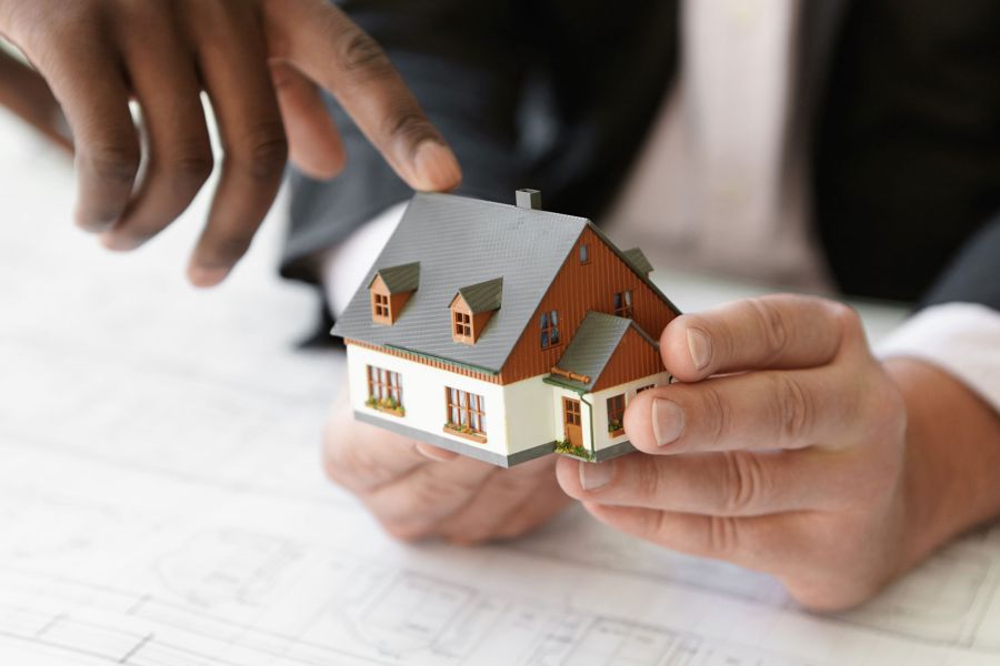 people pointing at model house